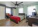Bedroom featuring modern ceiling fan, closet, wood floors, and natural light from windows at 413 Sandy Hill Dr, Longwood, FL 32779