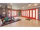 Finished home gym featuring workout equipment, red doors, and ample space for activities at 413 Sandy Hill Dr, Longwood, FL 32779
