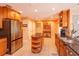 Large kitchen with granite countertops, stainless steel fridge, tile flooring, and ample storage space at 413 Sandy Hill Dr, Longwood, FL 32779