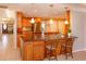Kitchen island featuring granite countertops, wooden cabinetry, and pendant lighting at 413 Sandy Hill Dr, Longwood, FL 32779