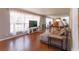 Bright living room with hardwood floors, large windows, and comfortable seating at 413 Sandy Hill Dr, Longwood, FL 32779