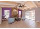Well-lit living room with a brick fireplace, beamed ceiling, and tiled flooring at 413 Sandy Hill Dr, Longwood, FL 32779