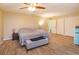 Bedroom features wood-look tile flooring, a ceiling fan, and ample closet space at 413 Sandy Hill Dr, Longwood, FL 32779