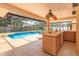 Luxurious pool area with a bar, perfect for outdoor entertaining and enjoying sunny days at 413 Sandy Hill Dr, Longwood, FL 32779