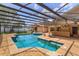 Inviting pool and spa in a screened-in enclosure, complemented by a bar for outdoor entertaining at 413 Sandy Hill Dr, Longwood, FL 32779