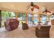 Relaxing screened porch with ceiling fans, outdoor furniture, and grill, overlooking the pool area at 413 Sandy Hill Dr, Longwood, FL 32779