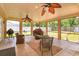 Enjoy outdoor living on the screened porch, complete with ceiling fans, furniture, and grill at 413 Sandy Hill Dr, Longwood, FL 32779