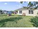 View of a spacious backyard with a playhouse and well-maintained lawn perfect for outdoor activities at 415 Anne St, Deland, FL 32724