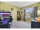 Comfortable bedroom featuring a large window with curtains, a desk, and a cozy atmosphere at 415 Anne St, Deland, FL 32724