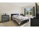 Bright bedroom with carpet flooring, large window, and neutral decor create a serene atmosphere at 415 Anne St, Deland, FL 32724