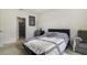Cozy bedroom with a large window, complemented by neutral decor and a comfortable sitting area at 415 Anne St, Deland, FL 32724