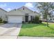 Charming single-story home with a lush green lawn and well-kept landscaping at 415 Anne St, Deland, FL 32724