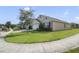 Well-manicured front lawn surrounds a charming single-story home, showcasing neighborhood street view and curb appeal at 415 Anne St, Deland, FL 32724