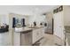 Bright kitchen features a central island with sink and stainless steel appliances at 415 Anne St, Deland, FL 32724