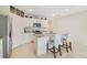 Open-concept kitchen with granite countertops, white cabinetry, and eat-in island at 415 Anne St, Deland, FL 32724