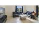 Comfortable living room with leather sofas, a large window, and tile flooring at 415 Anne St, Deland, FL 32724