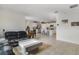 Spacious living room flowing into the kitchen, featuring tiled floors and a modern design at 415 Anne St, Deland, FL 32724