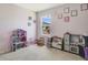 Bright playroom featuring a dollhouse, toy kitchen, and natural light from a window at 415 Anne St, Deland, FL 32724