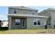 Backyard featuring a covered patio, green grass and an air conditioning unit to the side of the home at 4185 Sagefield Dr, St Cloud, FL 34773