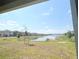 Backyard view featuring a serene pond and green space, creating a peaceful setting at 4185 Sagefield Dr, St Cloud, FL 34773