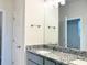 Bathroom featuring a granite countertop vanity, silver fixtures, and a large mirror at 4185 Sagefield Dr, St Cloud, FL 34773