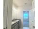 Bathroom featuring a double sink granite countertop vanity and an open doorway to a bedroom at 4185 Sagefield Dr, St Cloud, FL 34773