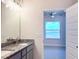 Bathroom features a double vanity with a granite countertop, connecting to the bedroom at 4185 Sagefield Dr, St Cloud, FL 34773