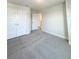 Bedroom featuring neutral carpet with double doors, and a doorway to an adjoining room at 4185 Sagefield Dr, St Cloud, FL 34773