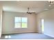 Bright bedroom with a ceiling fan, neutral paint, and a large window with a view at 4185 Sagefield Dr, St Cloud, FL 34773