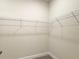 Walk-in closet features wire shelving for organization at 4185 Sagefield Dr, St Cloud, FL 34773