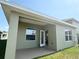 Exterior view of the home featuring a covered patio and well-maintained lawn at 4185 Sagefield Dr, St Cloud, FL 34773