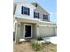 Charming two-story home featuring a two-car garage and black door, with neutral colored paint and simple landscaping at 4185 Sagefield Dr, St Cloud, FL 34773