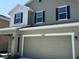 Two-story home featuring a two-car garage, and neutral color siding with black shutters at 4185 Sagefield Dr, St Cloud, FL 34773