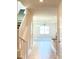 Bright foyer leads to an open-concept living area with tile flooring and a staircase on the left at 4185 Sagefield Dr, St Cloud, FL 34773