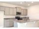 Modern kitchen features stainless steel appliances, gray cabinets, and a granite island at 4185 Sagefield Dr, St Cloud, FL 34773