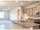 Modern kitchen with granite countertops, gray cabinets, and stainless steel appliances at 4185 Sagefield Dr, St Cloud, FL 34773