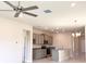 Open-concept kitchen with gray cabinets, modern appliances, and granite countertops at 4185 Sagefield Dr, St Cloud, FL 34773