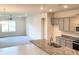 Stylish kitchen with granite countertops, gray cabinets, and an open floor plan at 4185 Sagefield Dr, St Cloud, FL 34773
