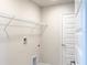 Clean and functional laundry room with shelving, washer and dryer hookups, and a white door at 4185 Sagefield Dr, St Cloud, FL 34773