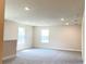 Open loft space with carpet floors, windows, and recessed lighting at 4185 Sagefield Dr, St Cloud, FL 34773