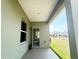 Covered patio overlooking a manicured lawn and a clear blue sky at 4185 Sagefield Dr, St Cloud, FL 34773