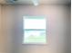 A bedroom's double-hung window offers lovely views of the adjacent lush green space and pond at 4185 Sagefield Dr, St Cloud, FL 34773