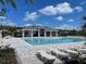 Luxury community pool area featuring a pool, lounge chairs, and covered seating at 4224 Sagefield Dr, Harmony, FL 34773