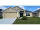 Charming single-story home featuring a manicured lawn and a two-car garage at 4224 Sagefield Dr, Harmony, FL 34773