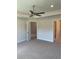 Cozy bedroom featuring neutral carpet, ceiling fan and tray ceiling at 4224 Sagefield Dr, Harmony, FL 34773
