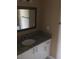 Granite countertop bathroom vanity with drawers and a framed mirror at 495 Las Cortes Ln # 206, Orlando, FL 32824