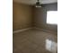 Cozy bedroom features tile flooring, ceiling fan, and a bright window at 495 Las Cortes Ln # 206, Orlando, FL 32824