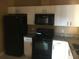 Kitchen featuring granite countertops, stainless steel sink, and white cabinets at 495 Las Cortes Ln # 206, Orlando, FL 32824