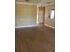 Open living area with laminated floors, neutral wall color and white trim throughout at 495 Las Cortes Ln # 206, Orlando, FL 32824