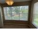 Bedroom view with large window overlooking lush greenery and a lake at 5164 Conroy Rd # 1526, Orlando, FL 32811